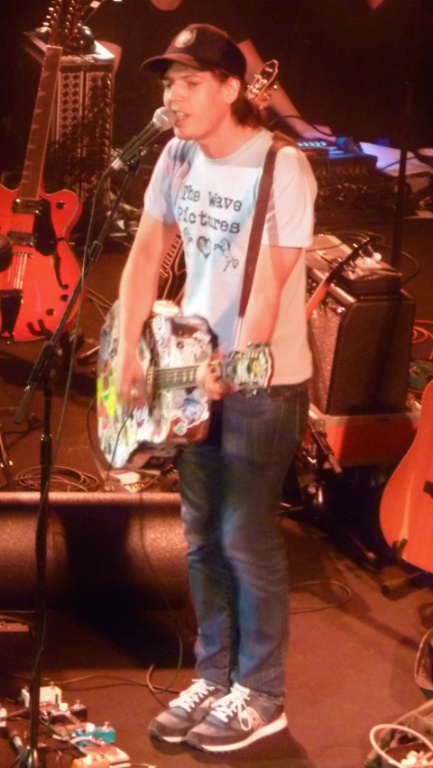 a person on a stage with a guitar