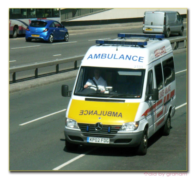 an ambulance going down a freeway with traffic