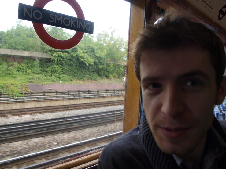 a man is taking a selfie at the window