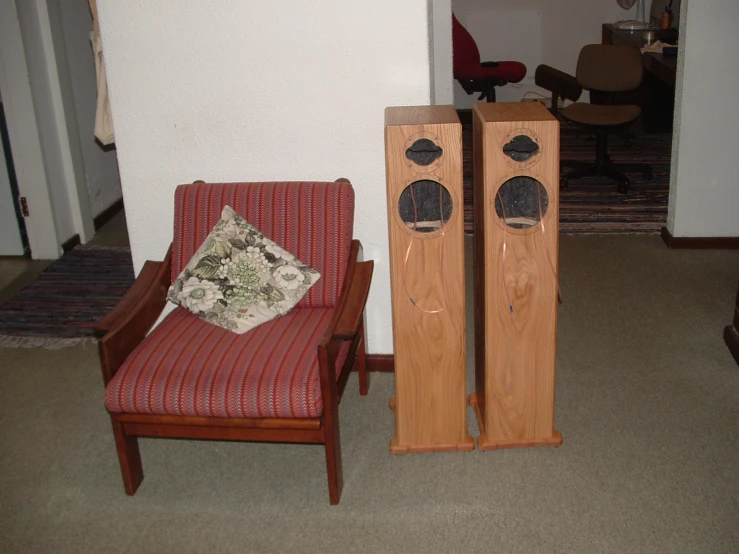 a pair of speakers sitting next to an old chair