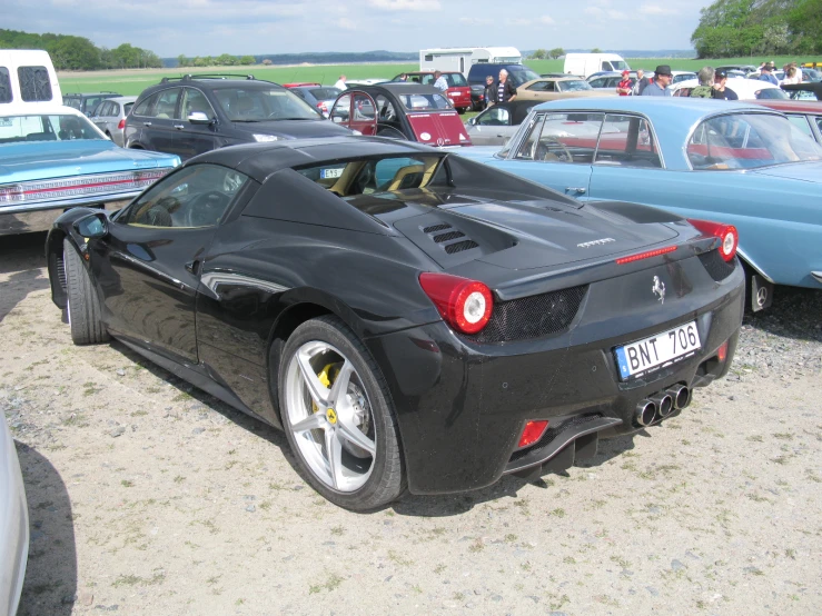 a black sports car parked in the parking lot