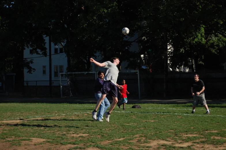 some guys playing with a soccer ball outside