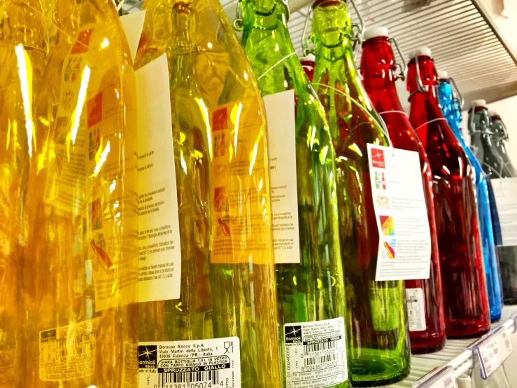 a row of different bottles sitting on top of a shelf