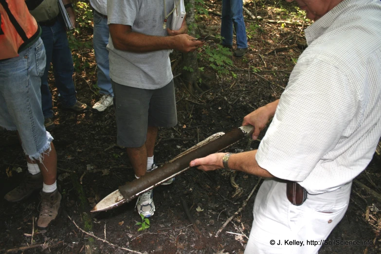 a man holding onto a big broken skateboard