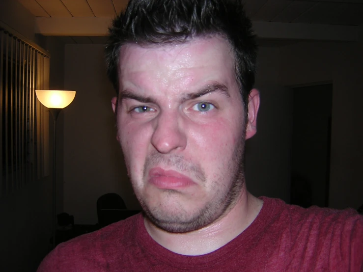 a close - up of a young man wearing a red shirt