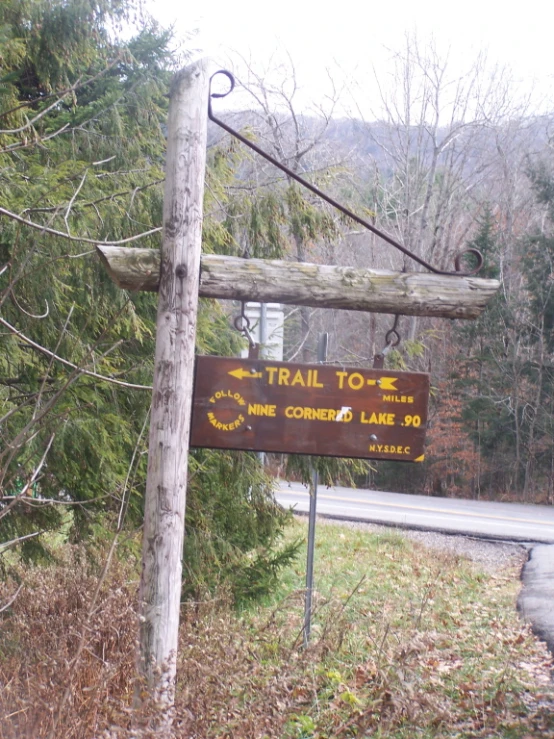 a wooden sign stating the trail to fine cown lake