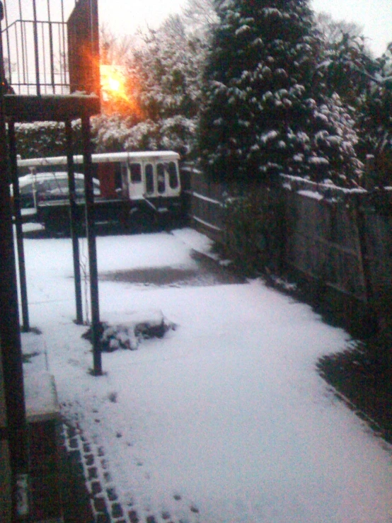 snow covers the grass outside on a snowy day