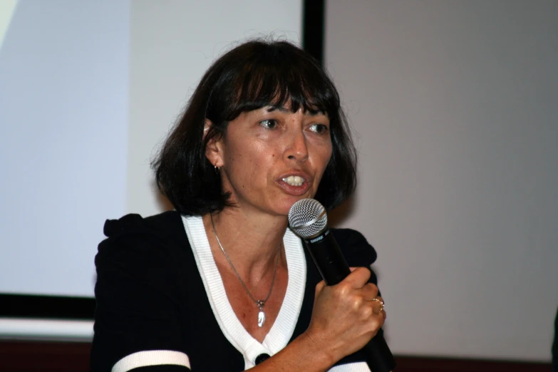 a woman giving a speech with a microphone