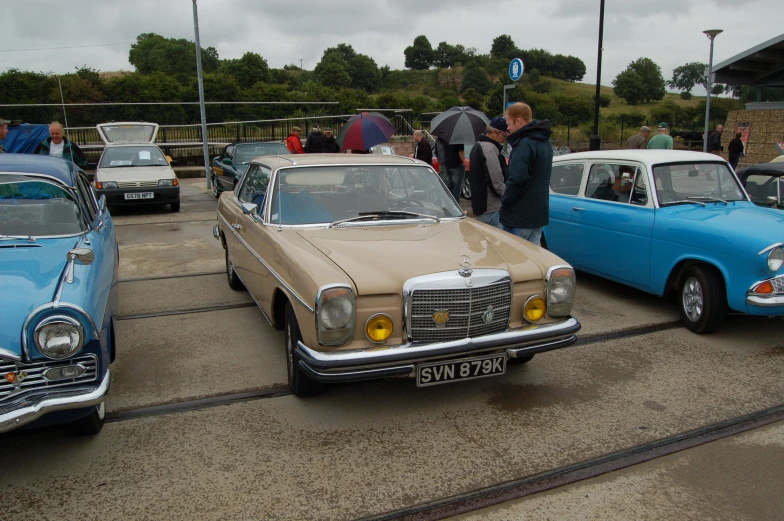 a couple of old cars that are parked in a lot