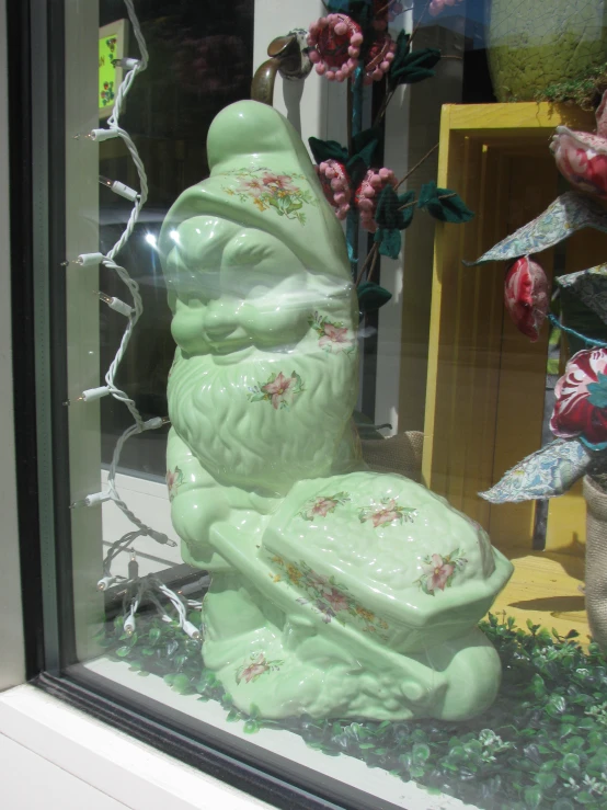 a sculpture made from green glass in a window