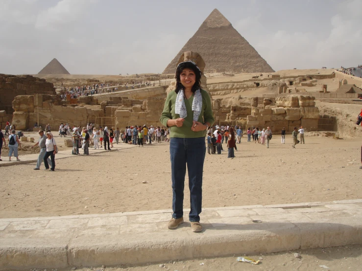 a woman standing in front of some pyramids