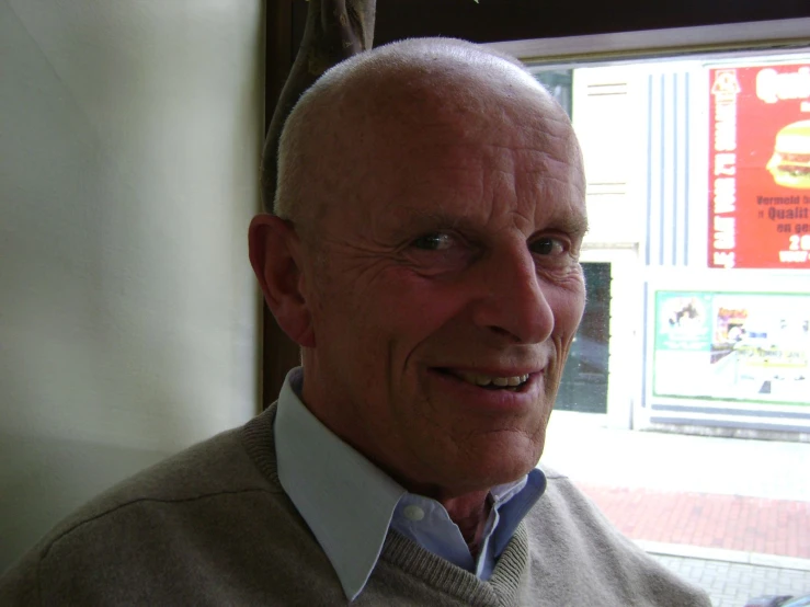 an older man with white hair looking to the side