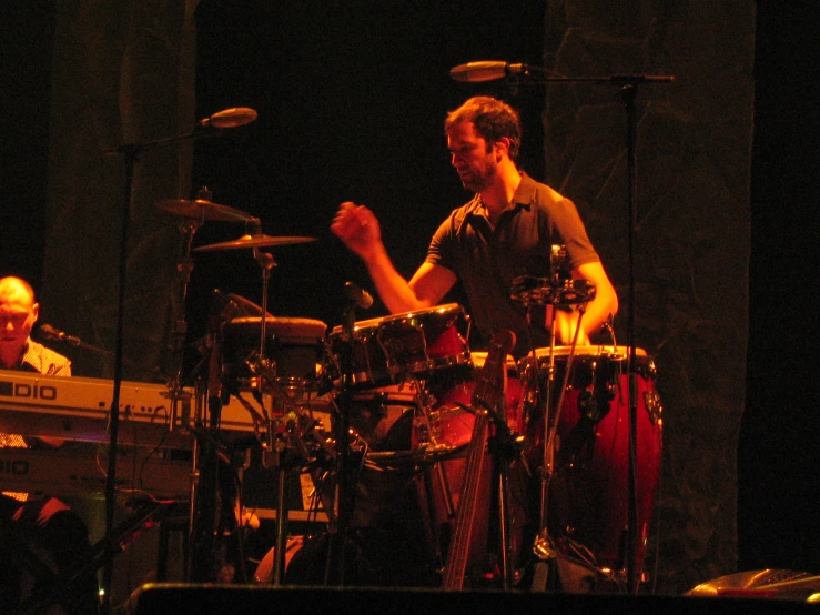 a man playing drums in a band with others around him