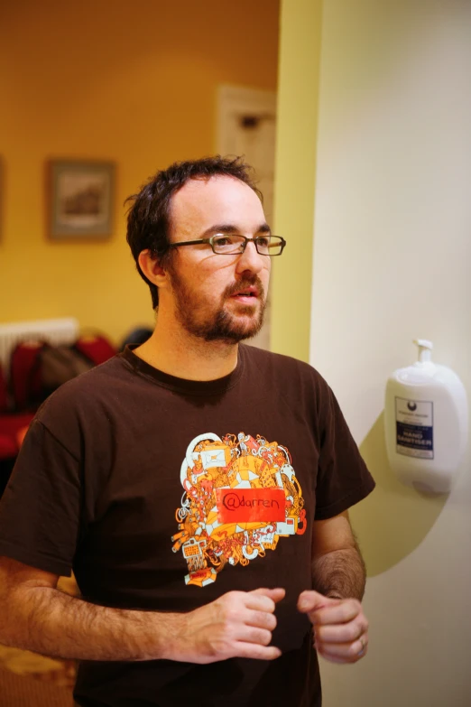 a man with glasses on is standing in the kitchen
