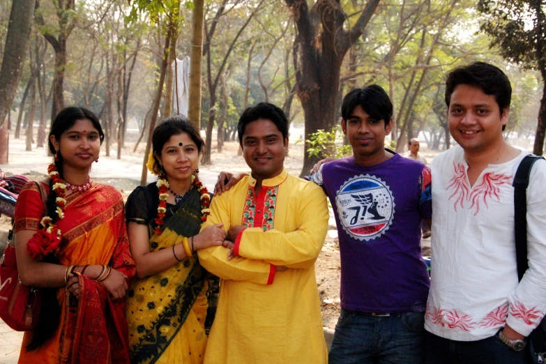 the group of people are standing together posing for a picture