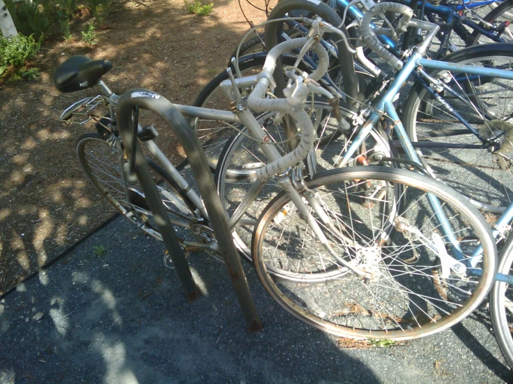 a group of bicycles parked up against a fence