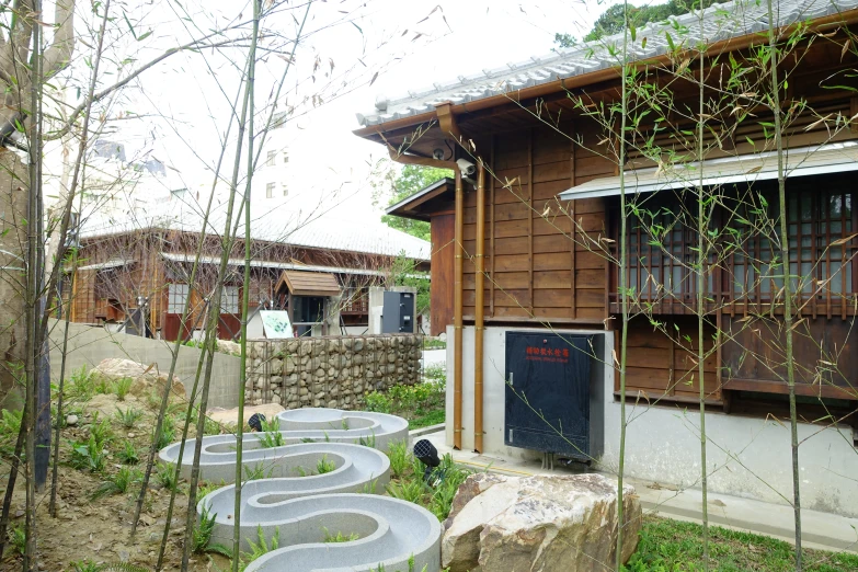 several circular stone garden markers in front of a building