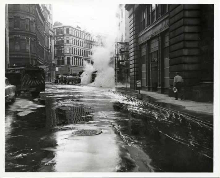 a black and white po of a street with steam coming out