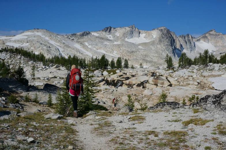 a hiker looks out on some mountain peaks