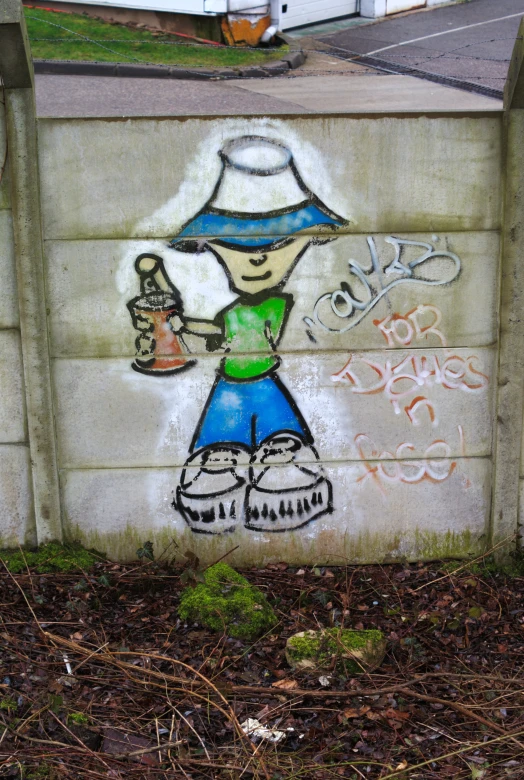 a graffiti in the corner of a concrete wall with writing and a person holding a bottle