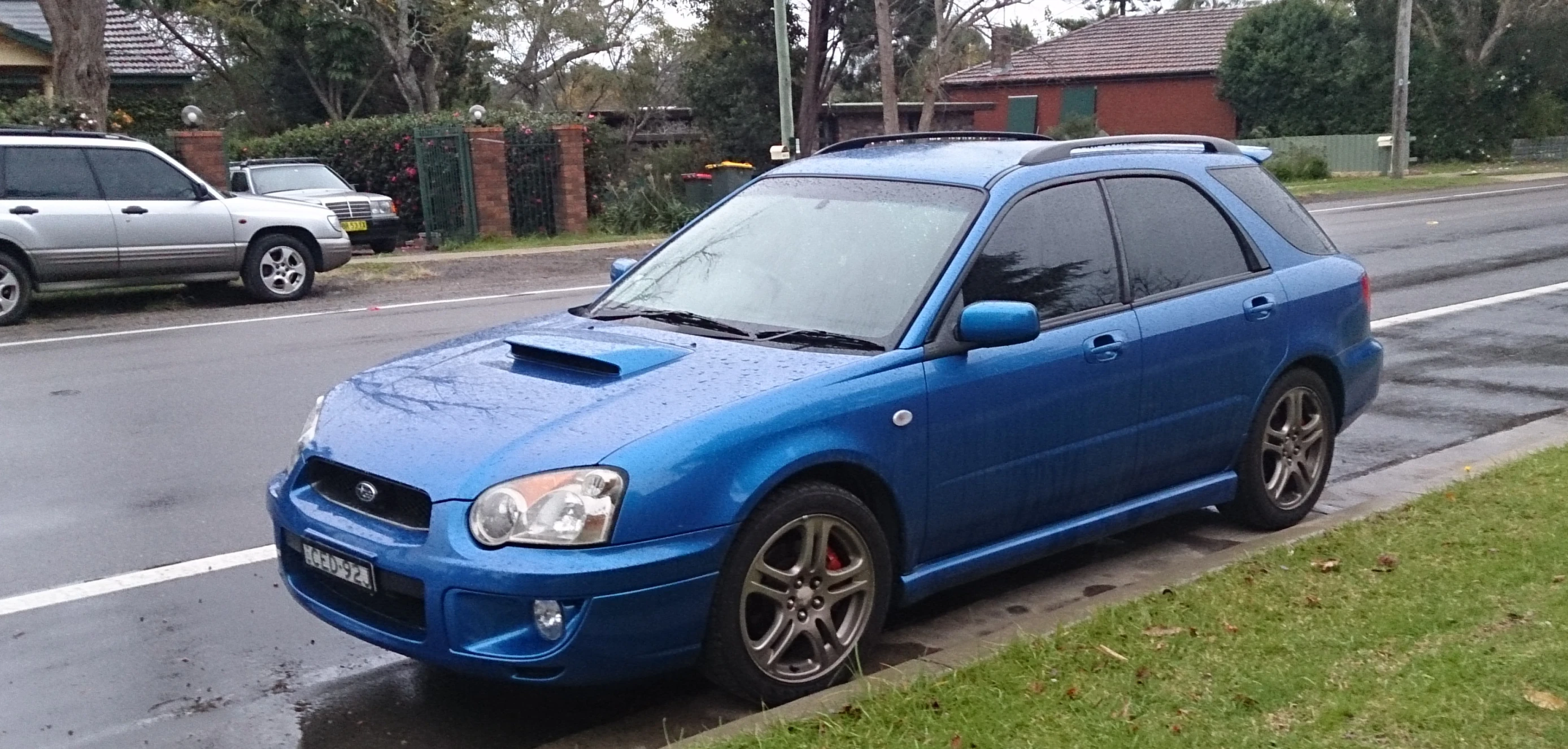 a blue car parked on the side of the road