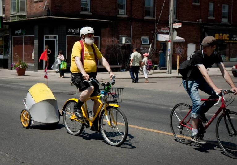 a couple of men are riding bikes down the street