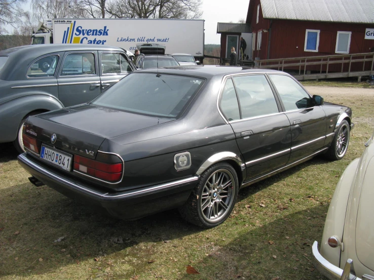 the black sedan has a license plate and has a silver one