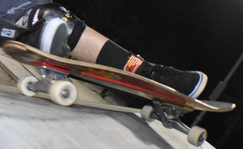a person with black and white sneakers on a skateboard