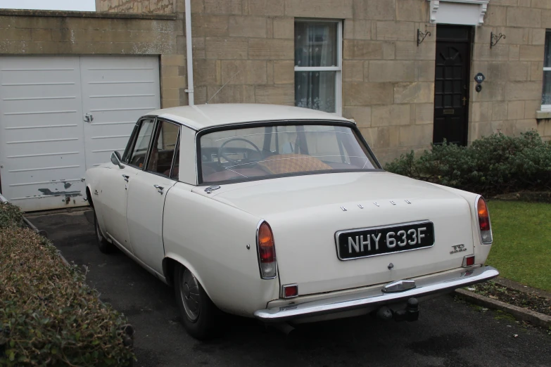 an old fashioned car parked in front of an older one