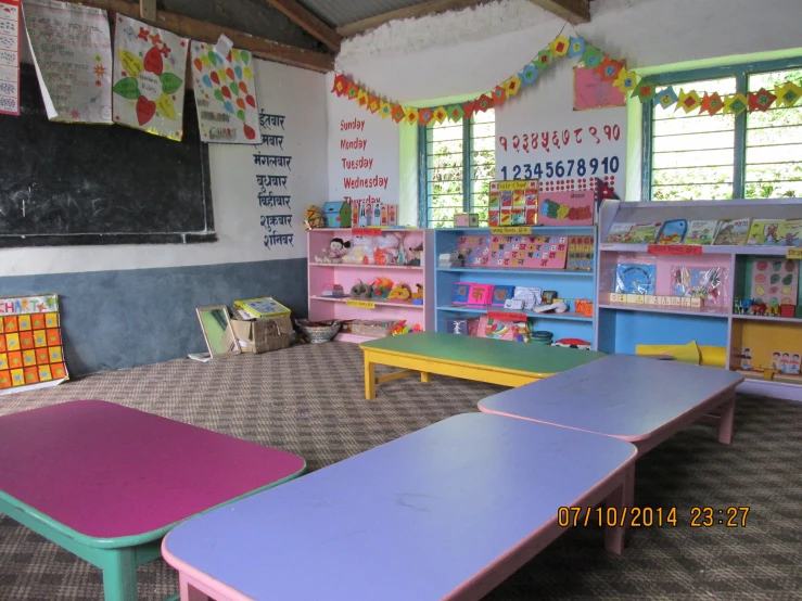 there are many bookshelves in the school room