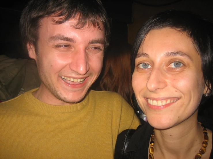 a young couple looking at the camera and smiling