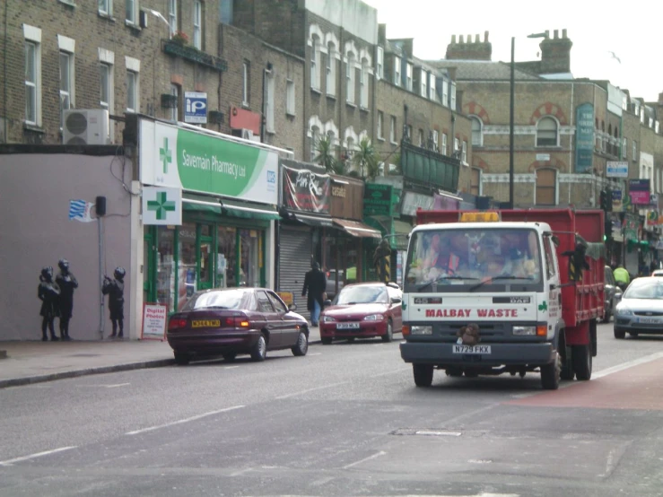 a vehicle is riding down a crowded city street