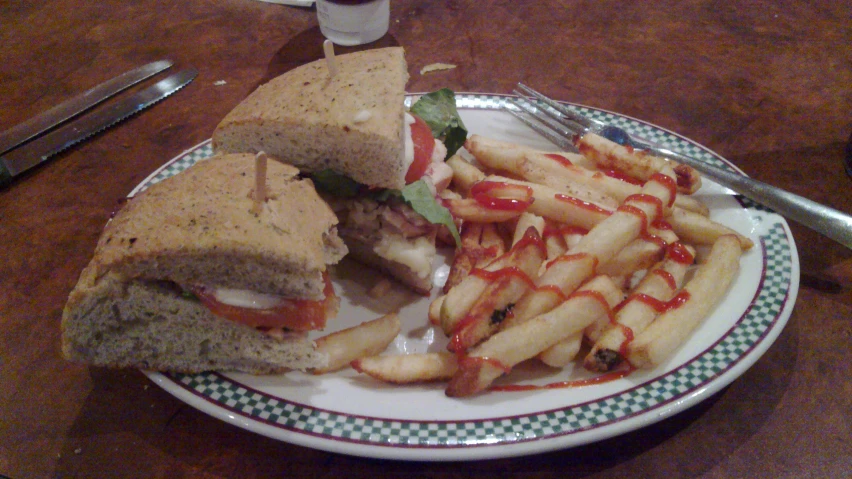 there is a plate with a sandwich and fries on it