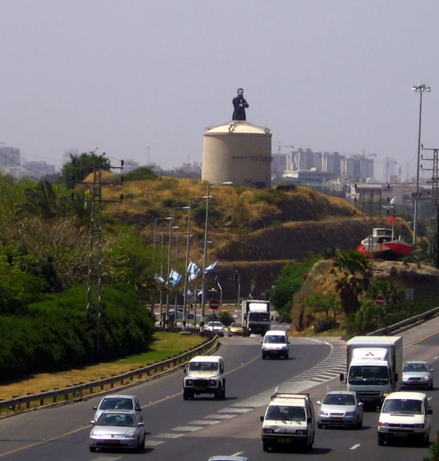 traffic on a busy road with a water tank