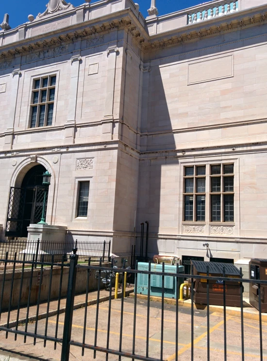 a building with an ornate design in front of a fence