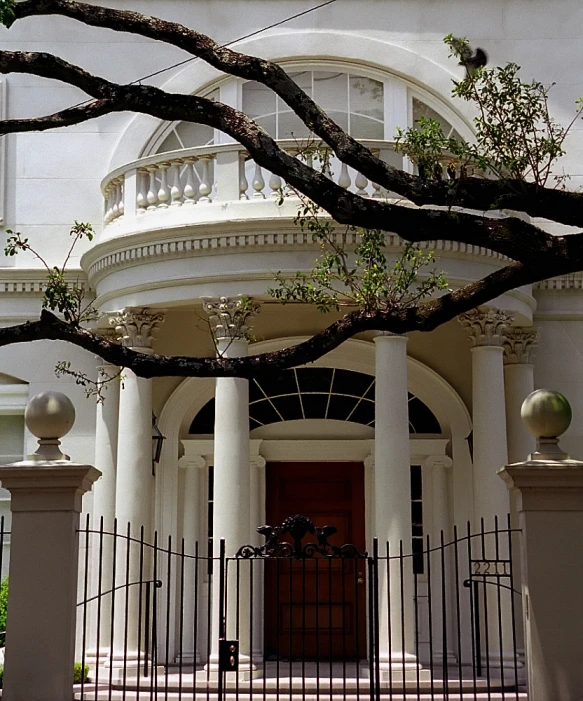 a large white building with columns and a red door