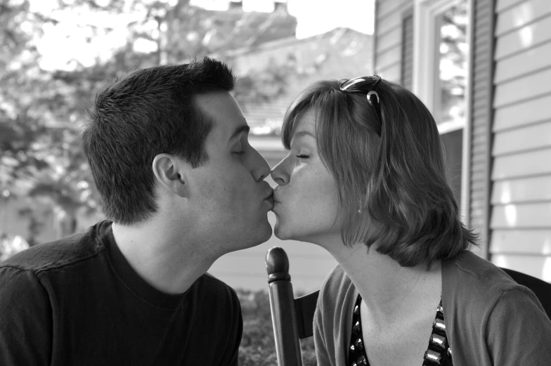 a man and woman sharing an adorable kiss