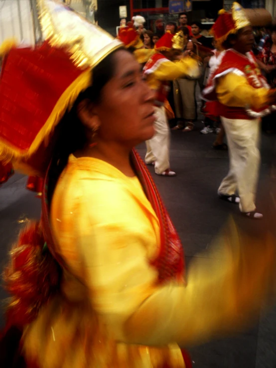 a woman is in motion carrying an umbrella in a parade