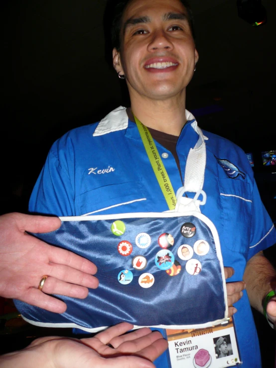 a man smiles as he shows off his belt