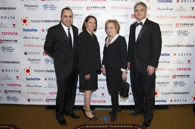 three people in suits and ties are posing for a po