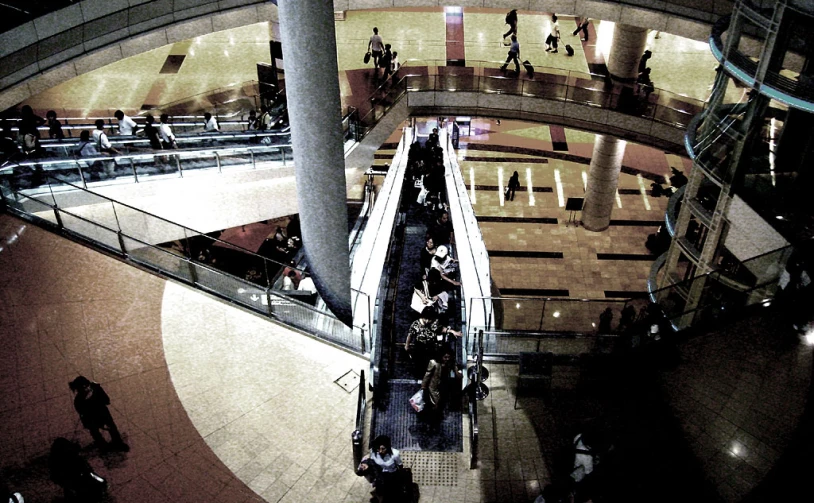people walking up and down an escalator in a building