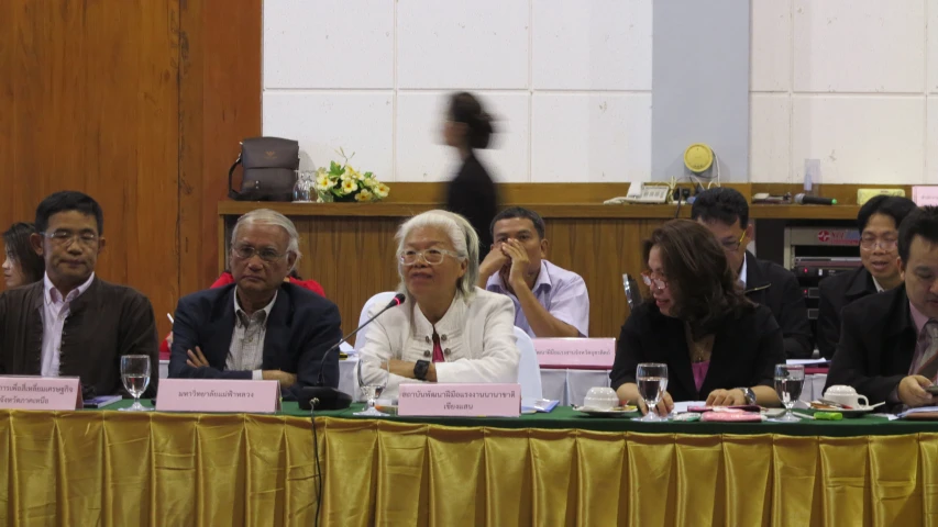 a group of people sit at a table talking