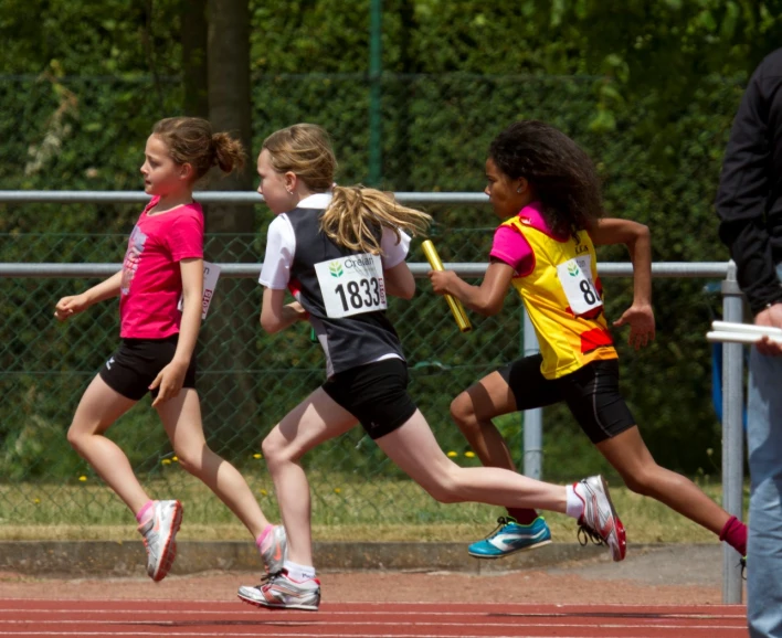five s race down a track in an outside athletics stadium