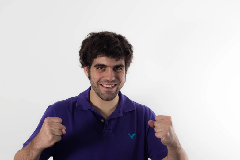 an image of man in purple shirt showing his muscles