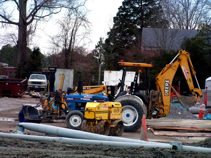 a construction site with two diggers and construction equipment