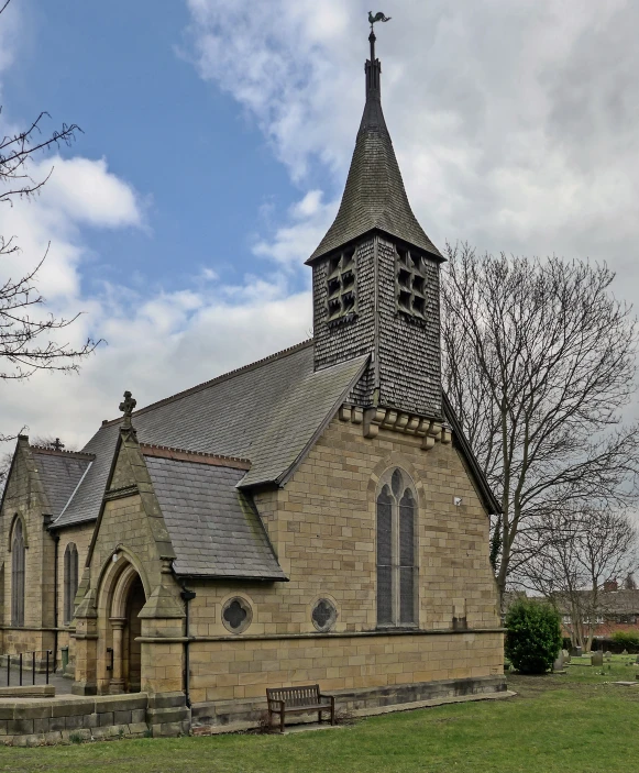 an old church sits on the corner of the grass