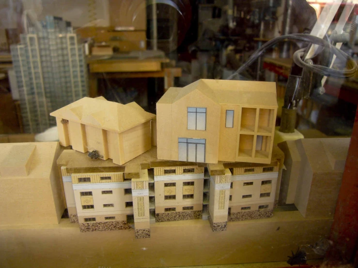 some wooden toy houses with windows in a display