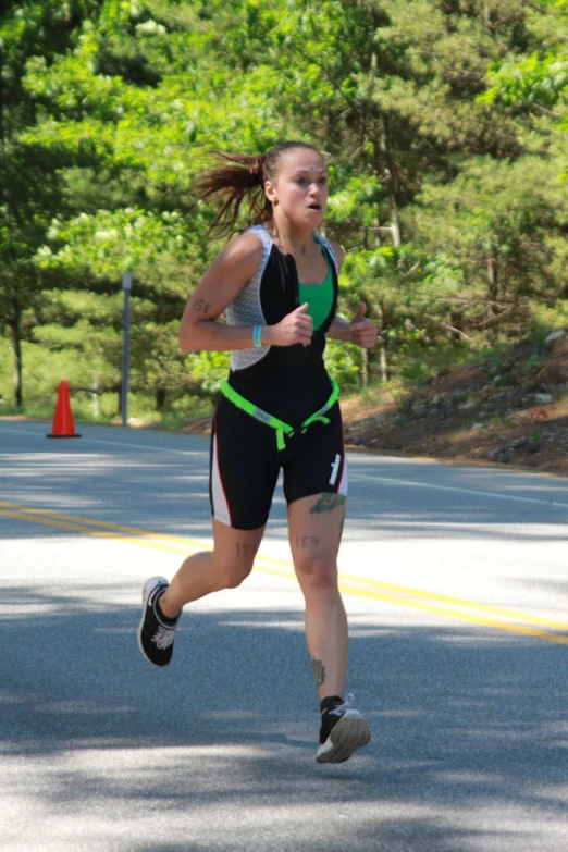 a woman running in a race on the road