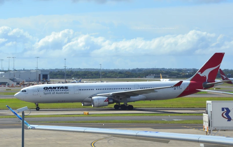 an airplane is parked on a runway near other planes