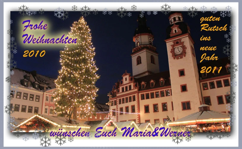 a christmas card is shown with a lit christmas tree in front